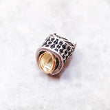 Silver and gold charm.