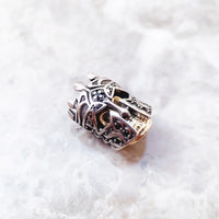 Ornate silver and gold bead.