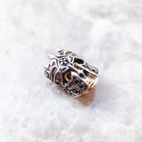 Ornate silver and gold bead.