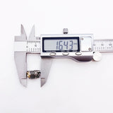 Digital caliper measuring a decorative metal bead.