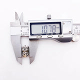 Silver and gold decorative bead being measured.