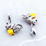Two silver mouse charms with yellow cheese.