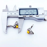 Silver mouse charm with yellow cheese.