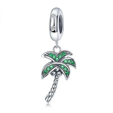 Silver palm tree charm with green stones.