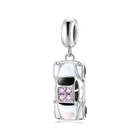 White car charm with pink accents.