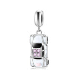 White car charm with pink accents.