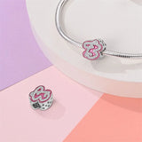 Pink and silver number 13 charm.
