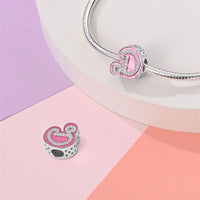 Pink and silver letter D charm.