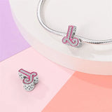 Pink and silver letter ’L’ charm.