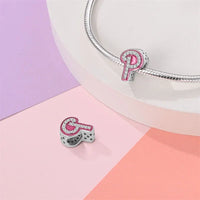 Pink and silver letter ’P’ charm.