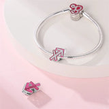 Silver charm bracelet with pink and crystal accents.