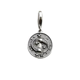 Silver pendant with intertwined snakes.