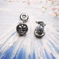 Two silver charms.