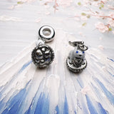Two silver charms.