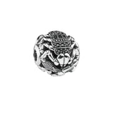 Scorpion-shaped charm with black stones.