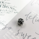 Silver rose charm.