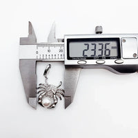 Crab pendant being measured.
