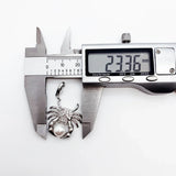 Crab pendant being measured.