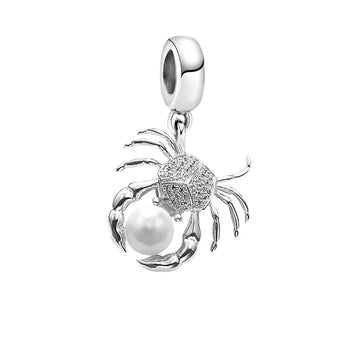 Crab-shaped charm with pearl.