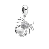 Crab-shaped charm with pearl.