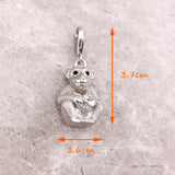 Silver monkey charm.