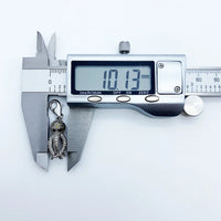 Octopus charm being measured.