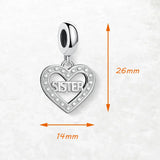 Silver heart-shaped charm with ’sister’ inscription.