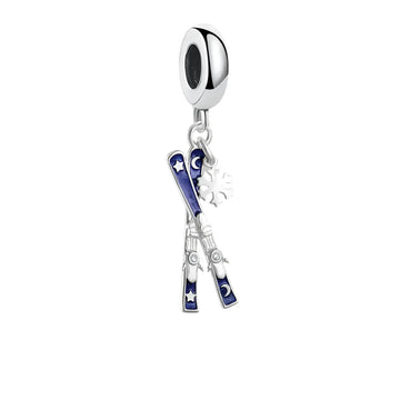 Silver charm with skis and snowflake.