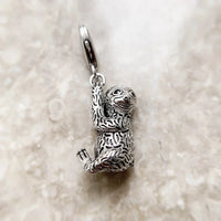 Silver sloth charm.