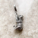 Silver sloth charm.