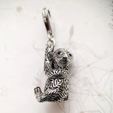 Silver sloth charm.