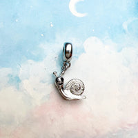 Silver snail charm.