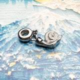Silver snail charm.