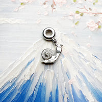 Silver snail charm.