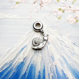 Silver snail charm.