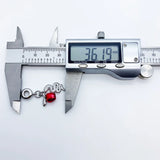 Snake charm bracelet being measured.