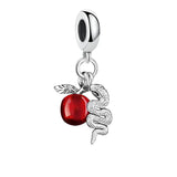 Silver charm with red apple and snake.