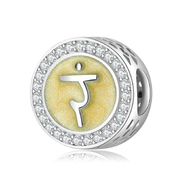Silver charm with yellow symbol and crystal accents.