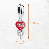 Heart-shaped lollipop charm.
