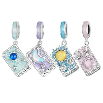 Four tarot card-themed charm pendants.