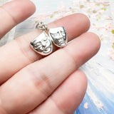 Silver comedy and tragedy masks pendant.