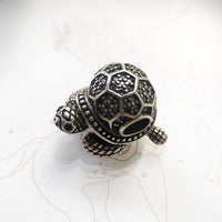 Silver turtle charm.