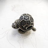 Silver turtle charm.