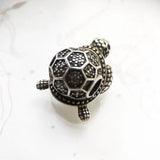 Silver turtle charm.