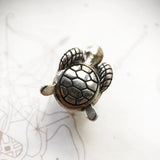 Silver turtle charm.