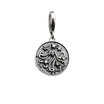 Silver pendant with a woman’s face.