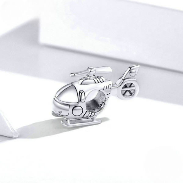 Sterling silver charm featuring a helicopter design