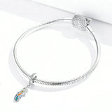colorful feather charm on bracelet